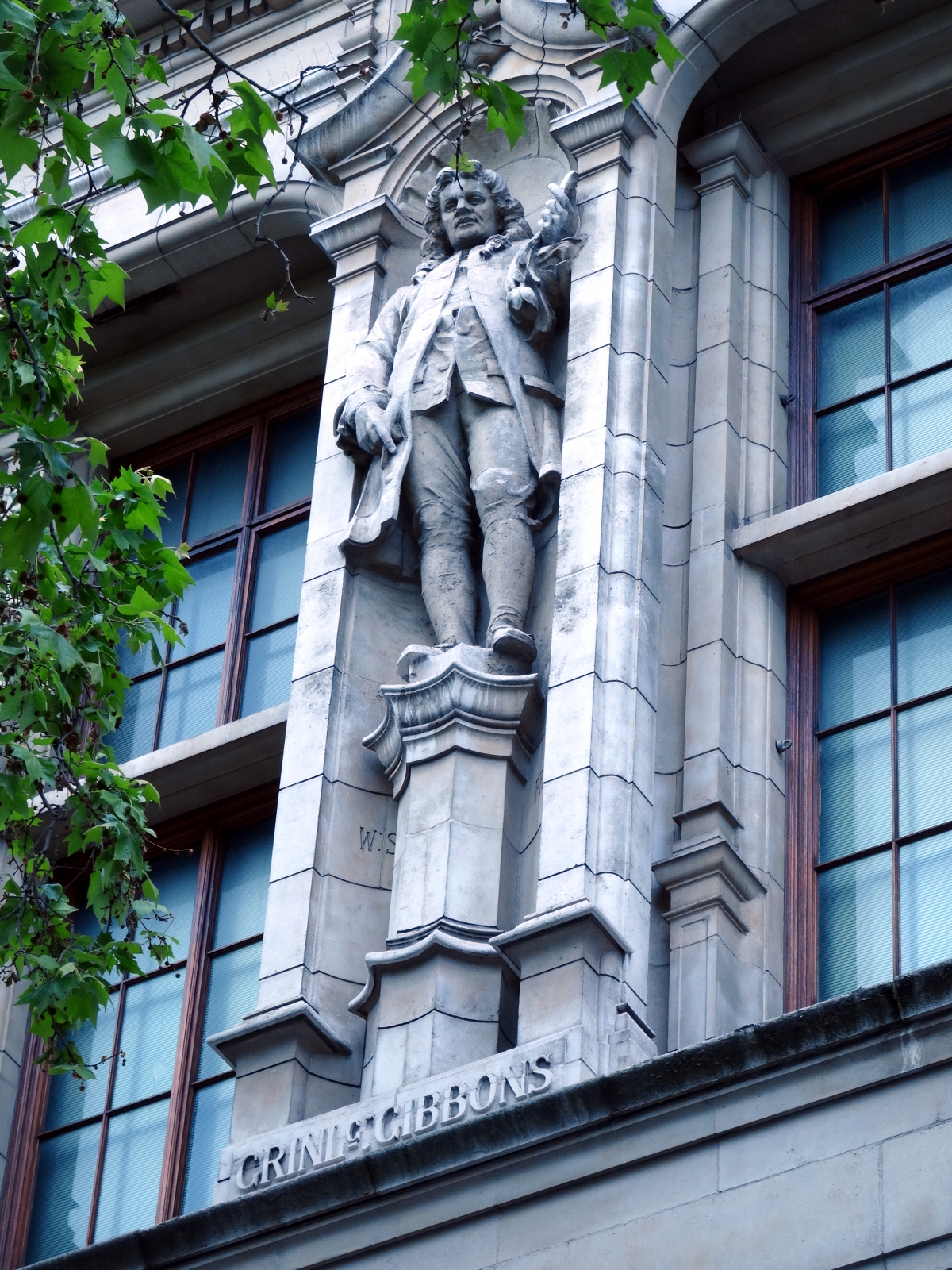 photo of a stone statue of Gibbons